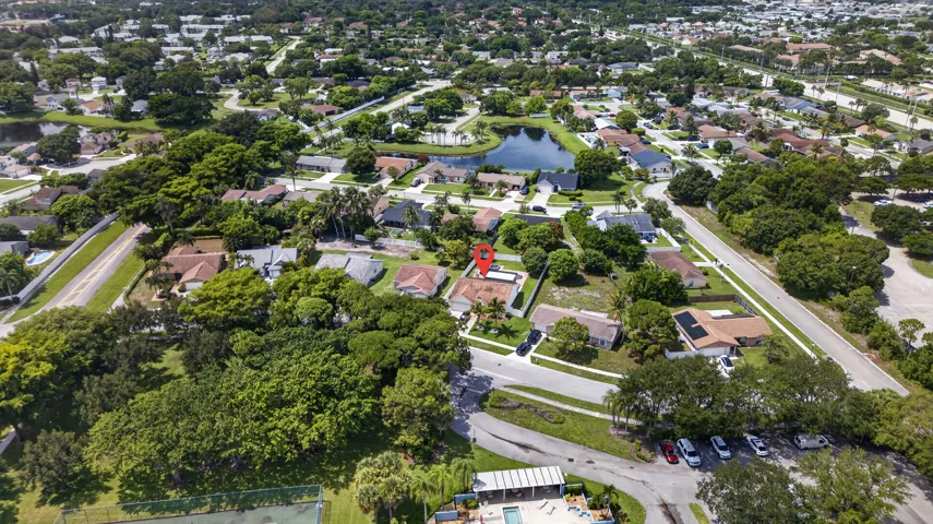 Aerial perspective of a residential neighborhood with mature trees and established homes
