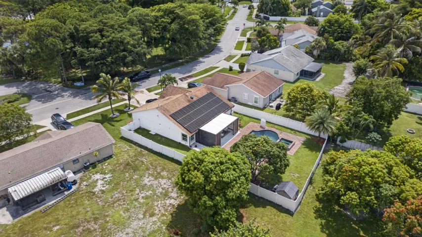 Single-story residence featuring a private backyard with an in-ground swimming pool, an attached covered patio, and a white privacy fence