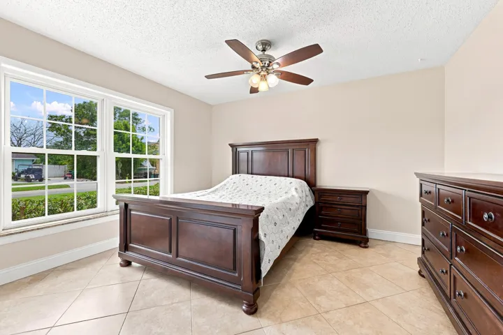Spacious room featuring neutral-toned walls and large double-hung windows