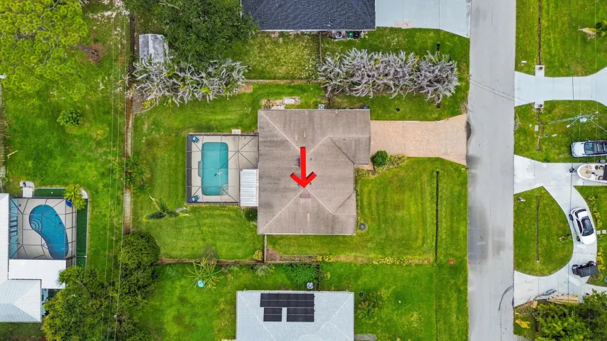 Single-story residence featuring a private swimming pool, concrete patio, and a pavered driveway