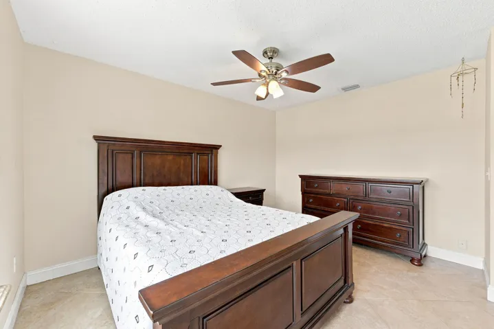 Spacious room featuring vaulted ceilings, light-colored wall paint, and tiled flooring