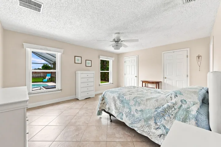 Spacious room featuring neutral wall tones and tile flooring