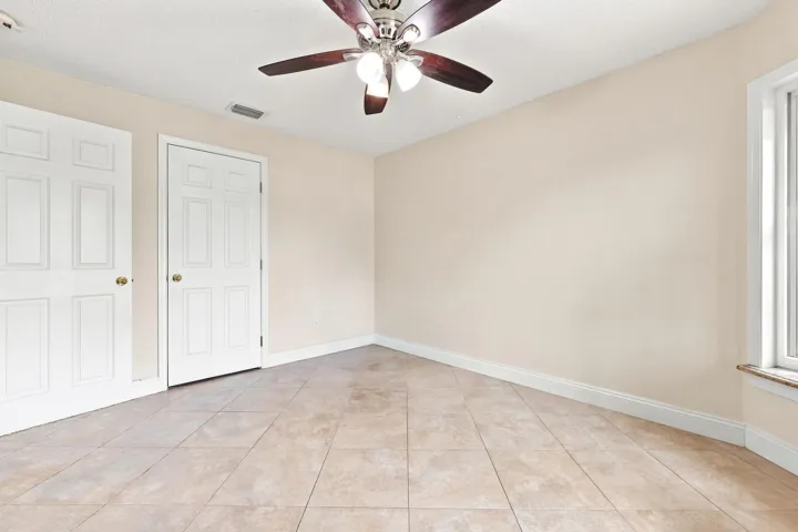 Neutral-toned ceramic tile flooring extending throughout the room