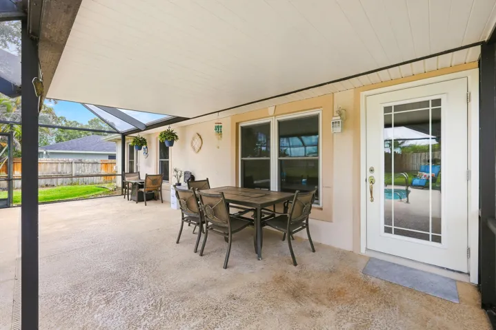 Covered patio with textured concrete flooring and a white paneled ceiling