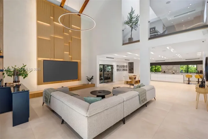 Every detail reflects thoughtful craftsmanship—from the custom millwork and integrated media wall to the dramatic ceiling heights that define the home’s architectural character.