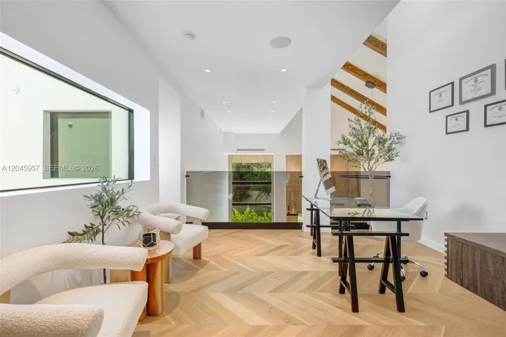 An inspiring upper-level office overlooking the great room offers the perfect balance of openness, privacy, and natural light.