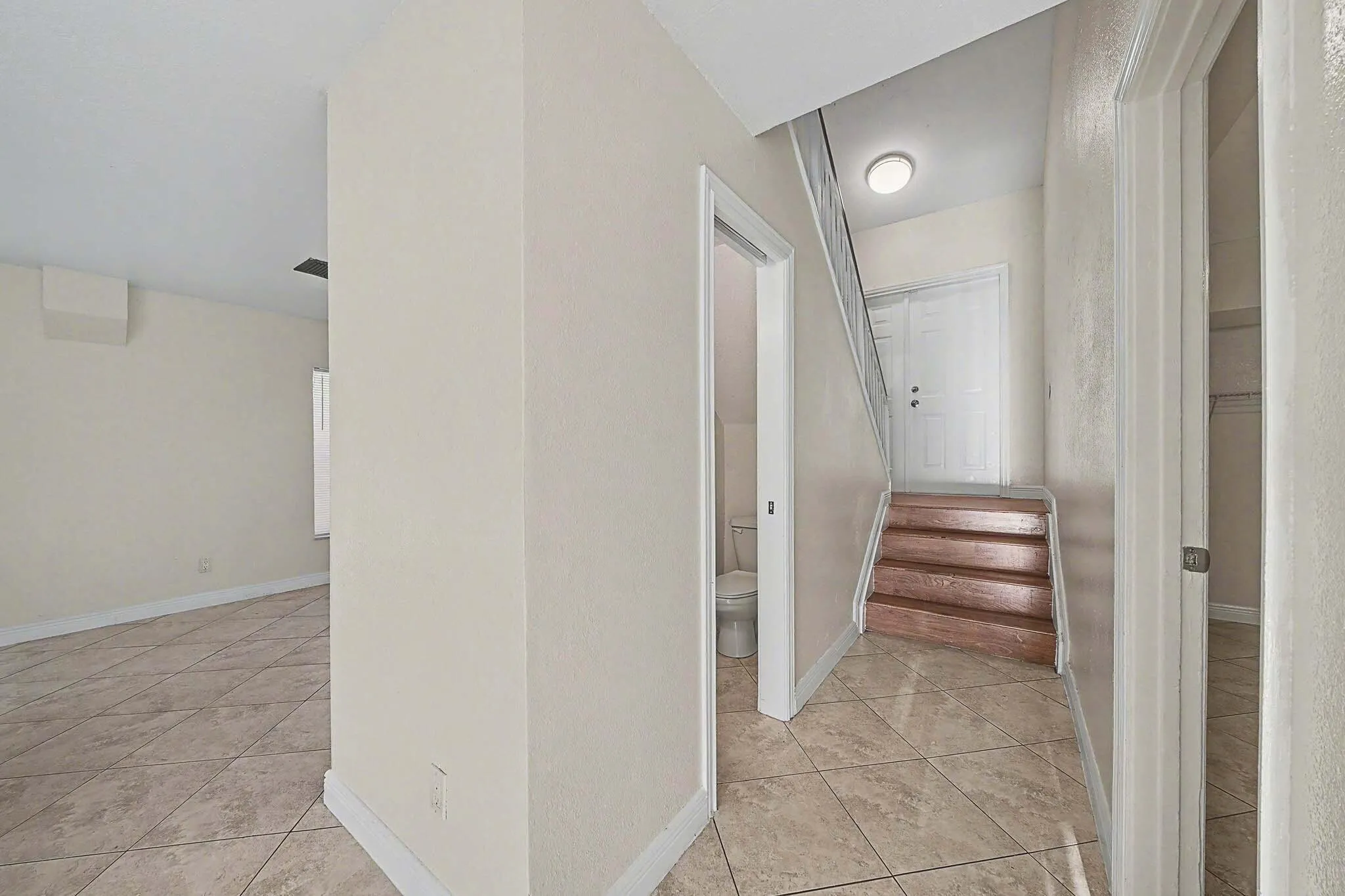 Tiled flooring throughout entryway and living space