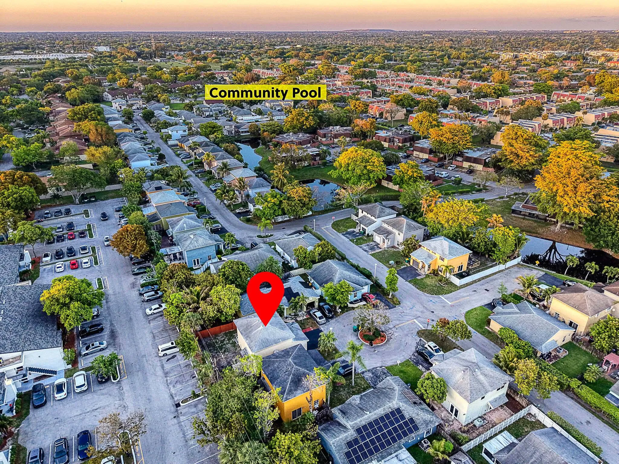 Aerial perspective showcasing a residential neighborhood with a variety of single-family homes and mature trees