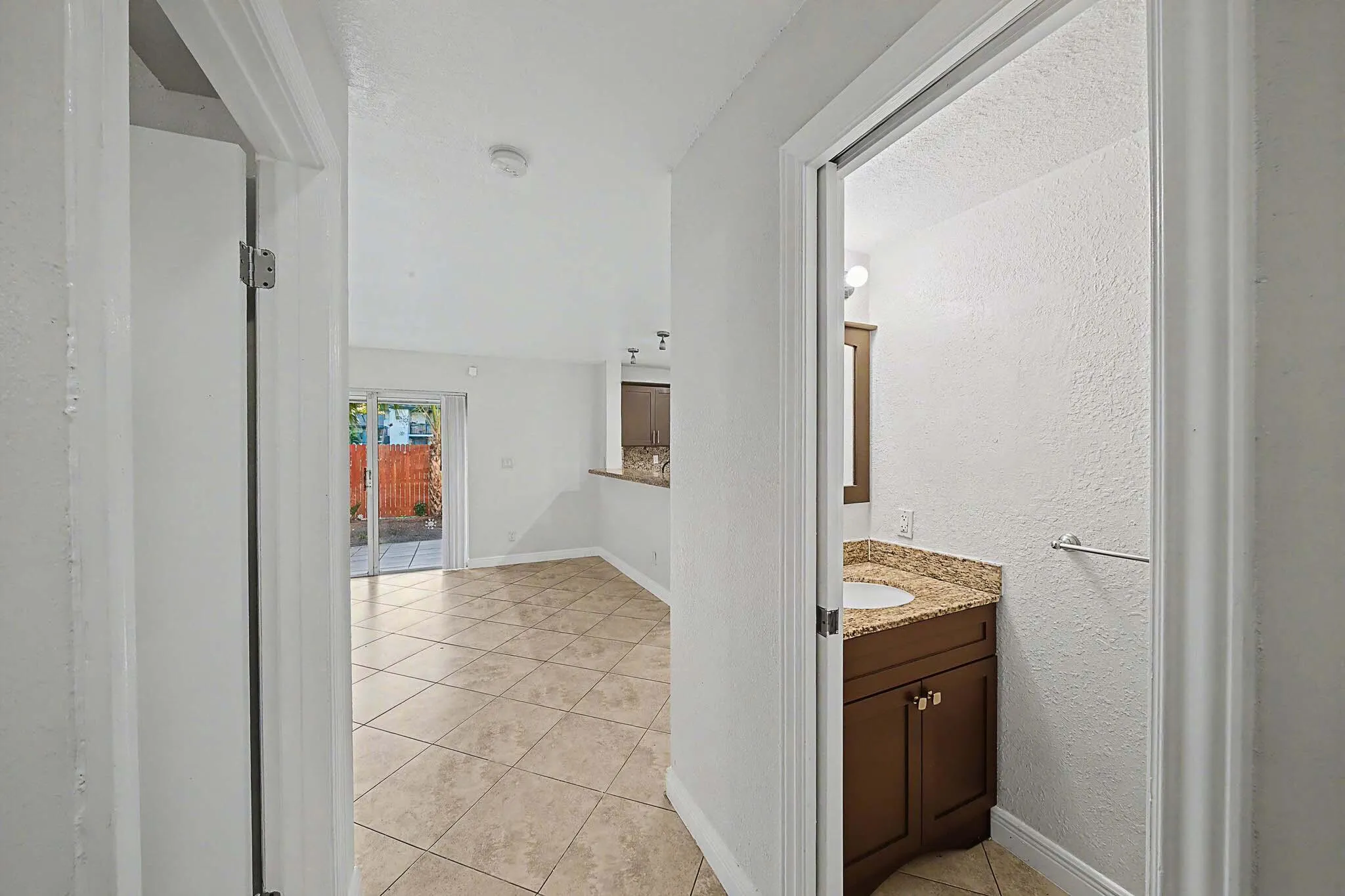 Interior hallway featuring tile flooring and white walls