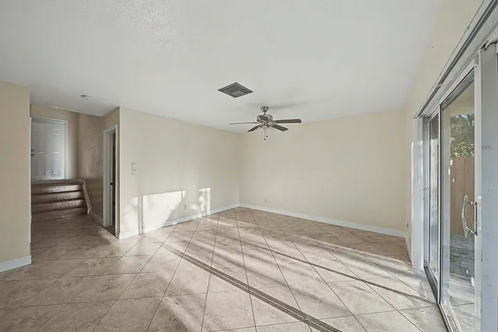 Spacious interior featuring neutral-toned walls and diamond-set tile flooring