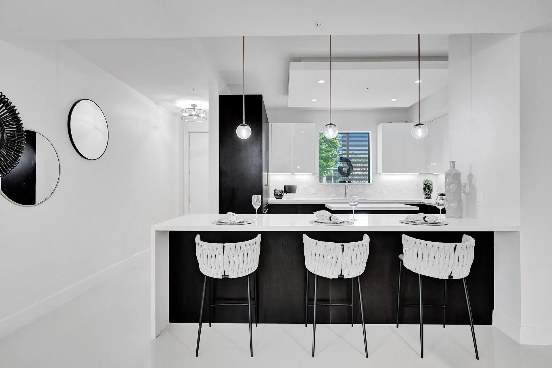 Modern kitchen with a white countertop island and dark wood-finish base cabinetry