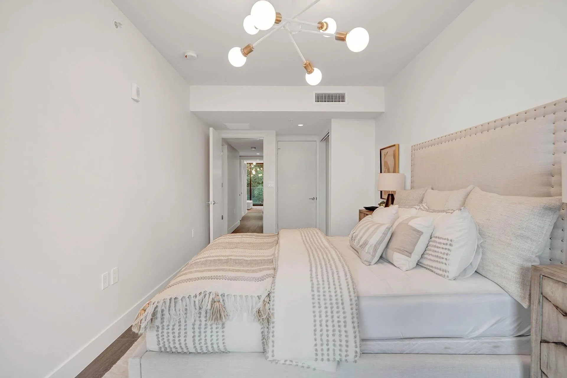 Bedroom featuring a contemporary sputnik chandelier and wood-finish flooring