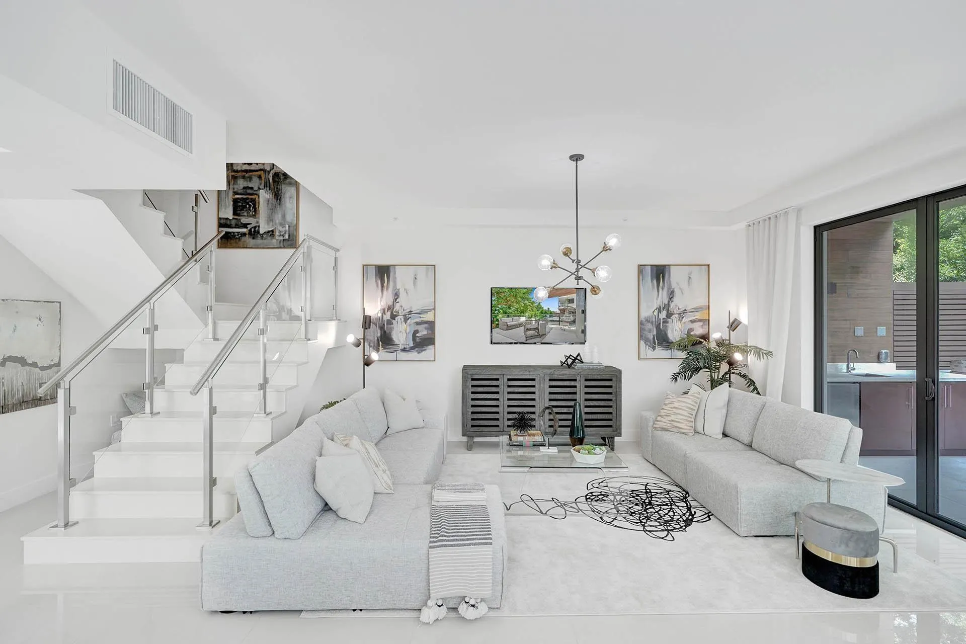 Contemporary living area featuring bright white walls and polished tile flooring