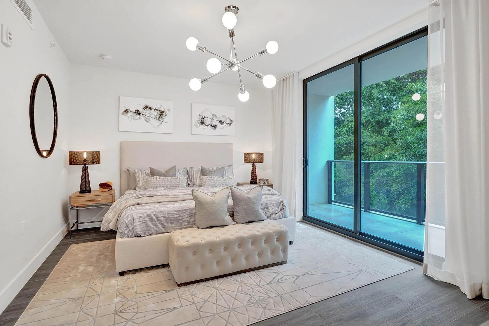 Sliding glass doors opening to a private balcony with glass railings