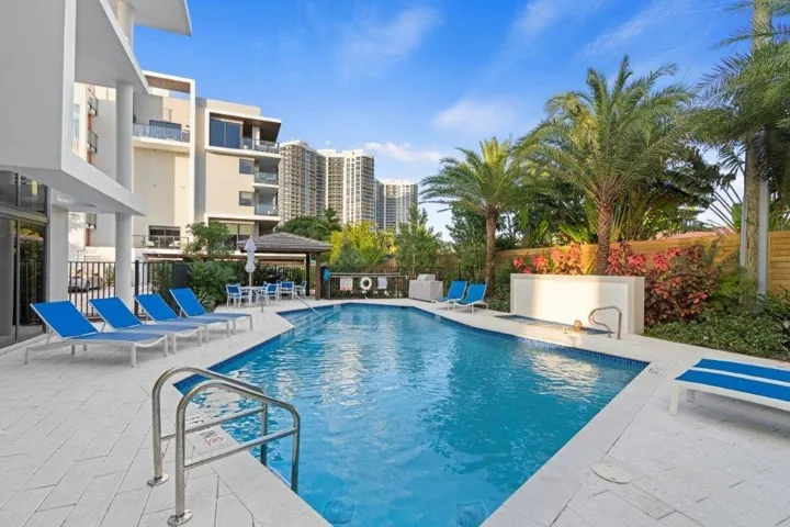 Rectangular swimming pool with white tile surround