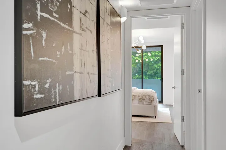 Hallway featuring wood-finish flooring, white walls, and recessed lighting