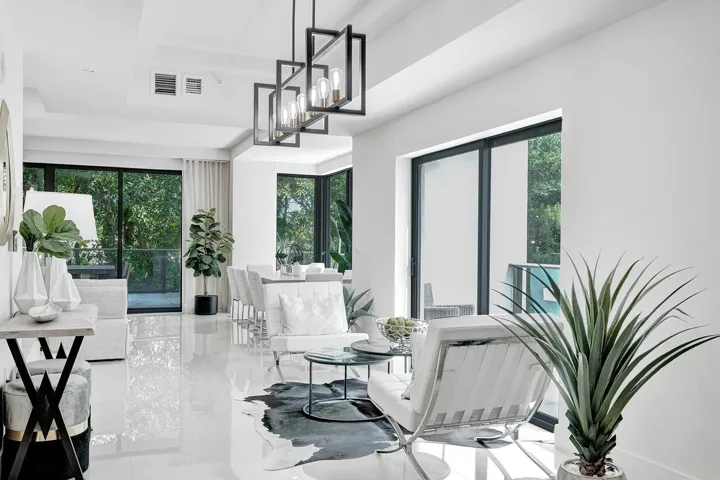 Open-concept living area featuring high-gloss tile flooring and floor-to-ceiling sliding glass doors