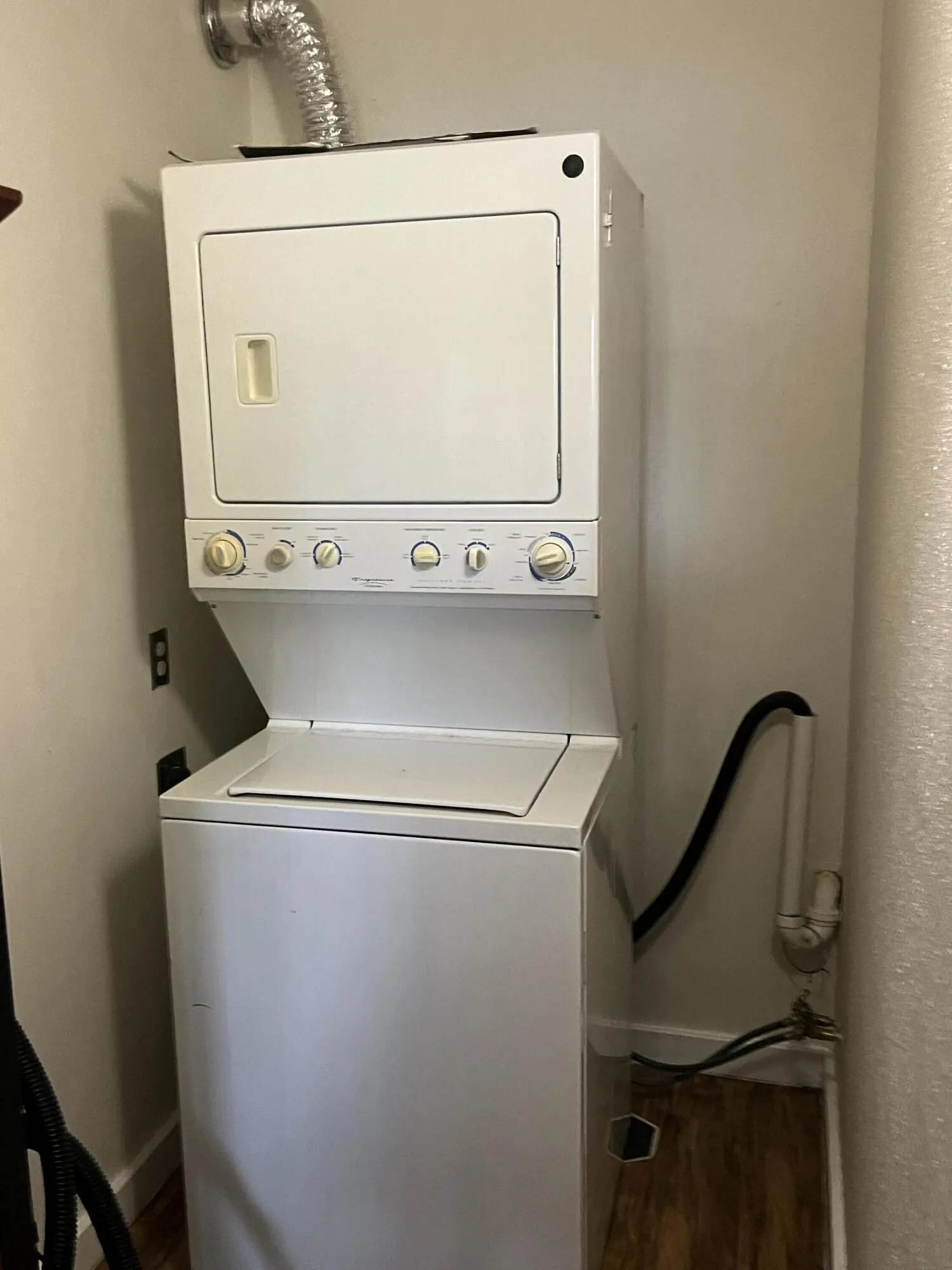 walk-in closet in primary bedroom has an oversized stackable washer/dryer