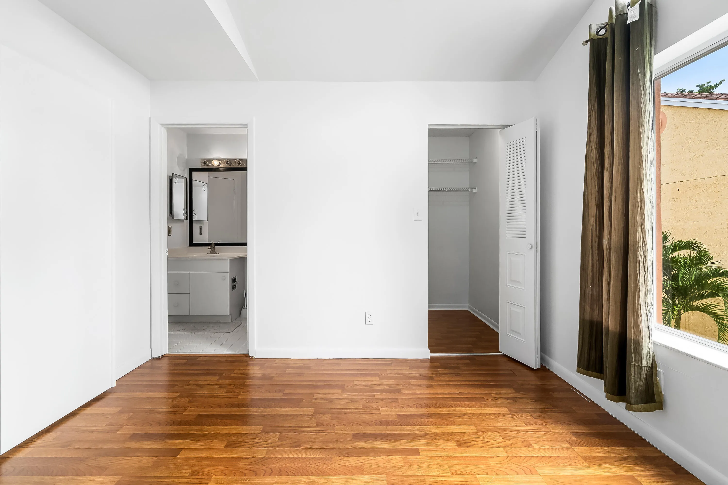 Guest bedroom with vaulted ceilings and lots of natural light