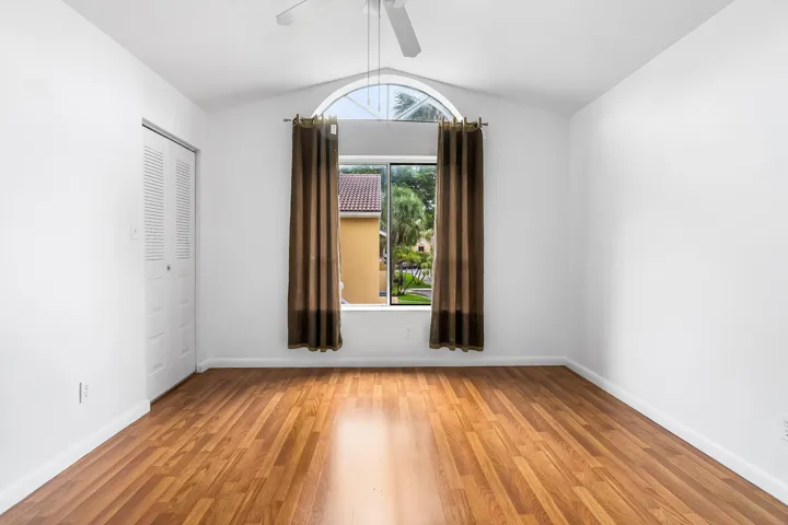 Guest bedroom with vaulted ceilings and lots of natural light