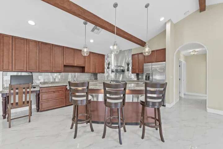 Eat in island countertop with stunning stainless backsplash NOTICE ARCHWAY
