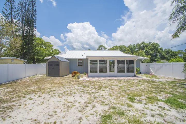 Fenced Back yard with storage shed and Florida room