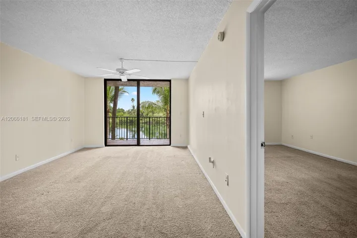 View towards living room, balcony, lake and part of the bedroom