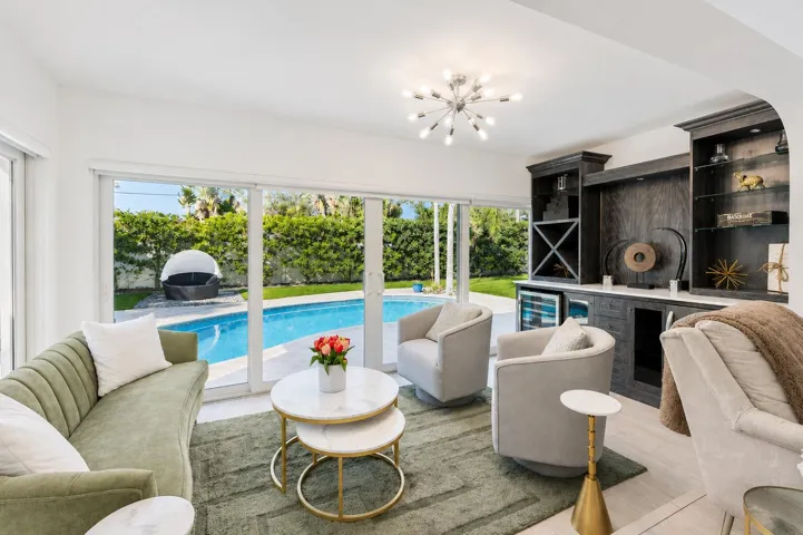 Living area with wood-finish flooring, built-in cabinetry, and integrated beverage coolers