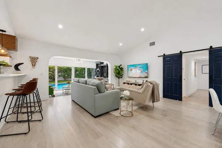 Spacious interior featuring wood-finish flooring, vaulted ceilings, and recessed lighting
