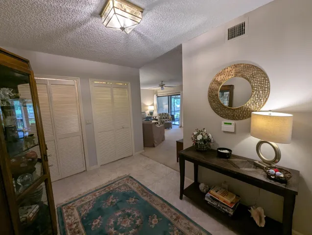 Entryway featuring tile flooring, louvered bi-fold doors, and a ceiling-mounted light fixture