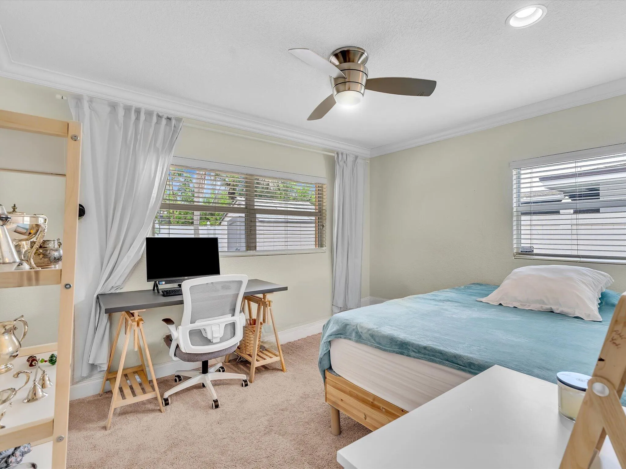 Recessed lighting, crown molding, a ceiling fan with integrated lighting, and carpeted flooring
