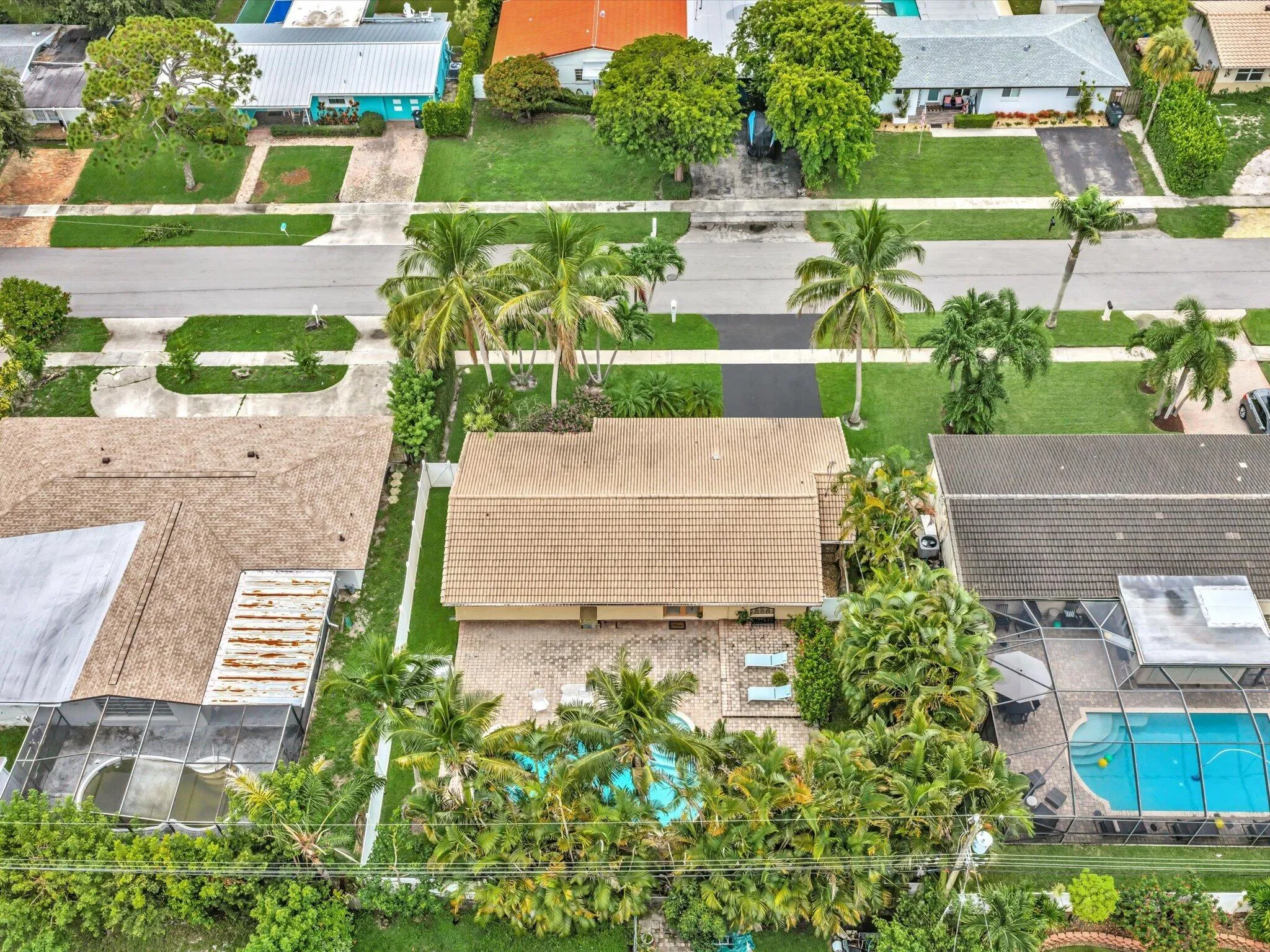 Tiled roof property with a private pool and surrounding mature landscaping
