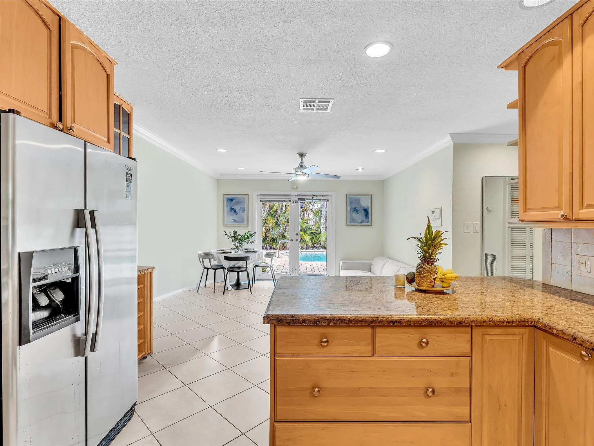 Kitchen with wood cabinetry, light-toned countertops, and stainless steel appliances