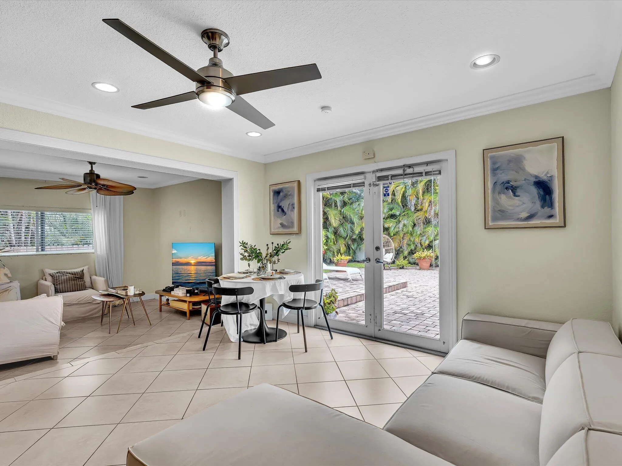 Recessed lighting, tile flooring, ceiling fans, crown molding, and patio access