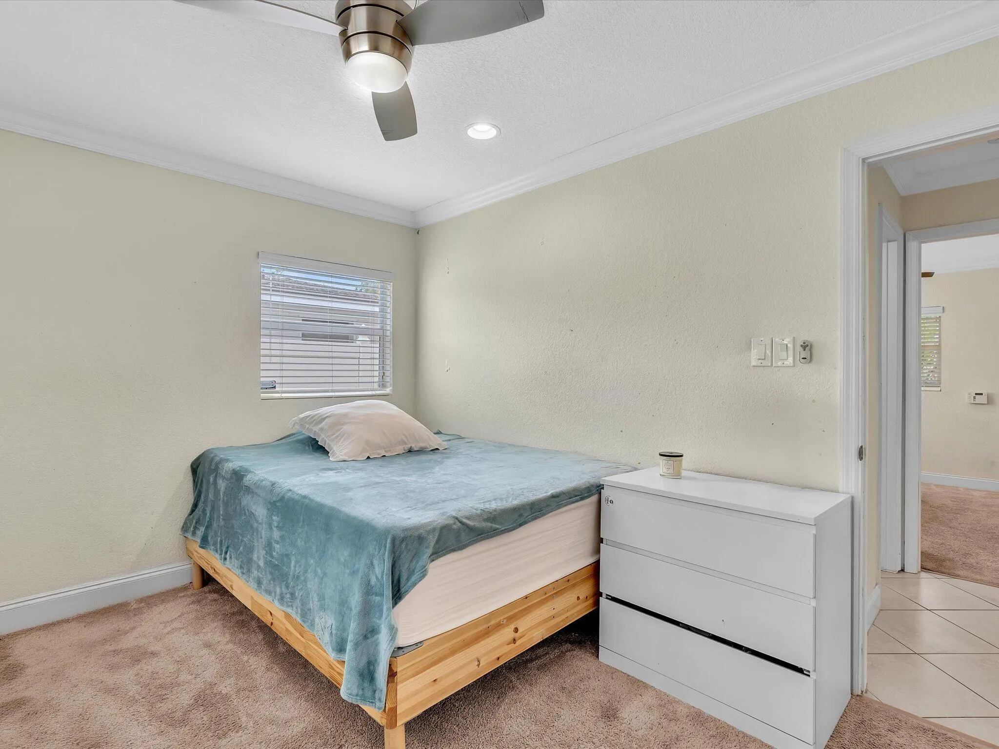 Recessed lighting, crown molding, ceiling fan, and carpeted flooring