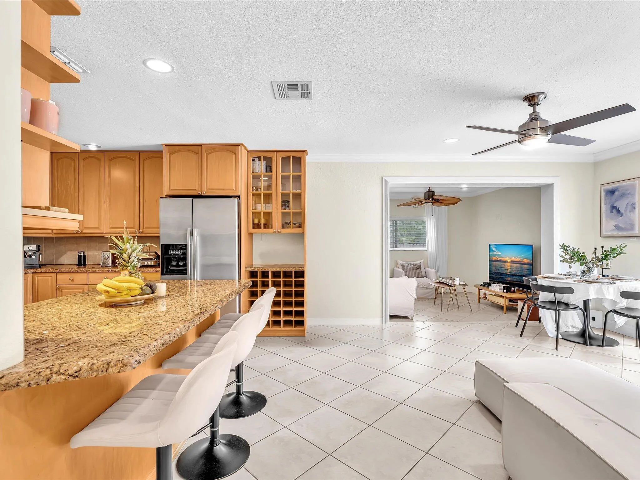 Kitchen with wood cabinetry, granite-finish countertops, and stainless steel appliances