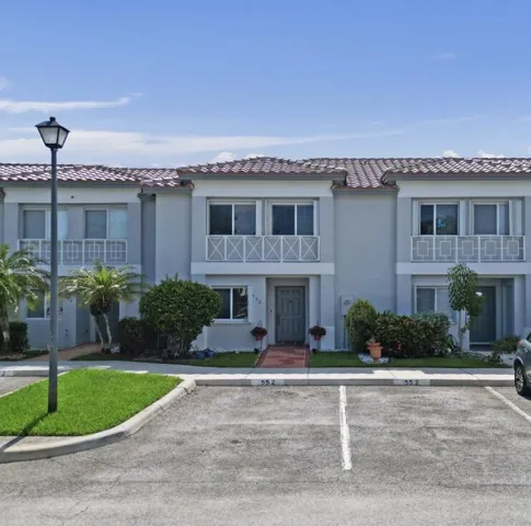 Townhouse with new tile roof and 2 parking spaces up front plus guest parking.