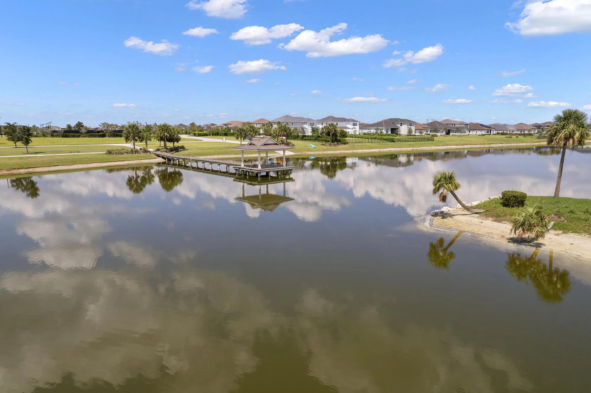 Expansive water feature with a pier and covered gazebo