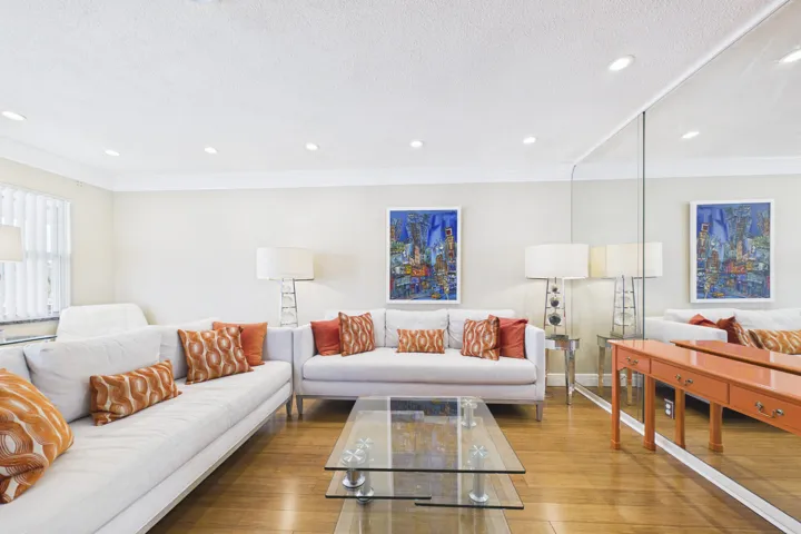 Living area featuring light wood-finish flooring and recessed ceiling lighting
