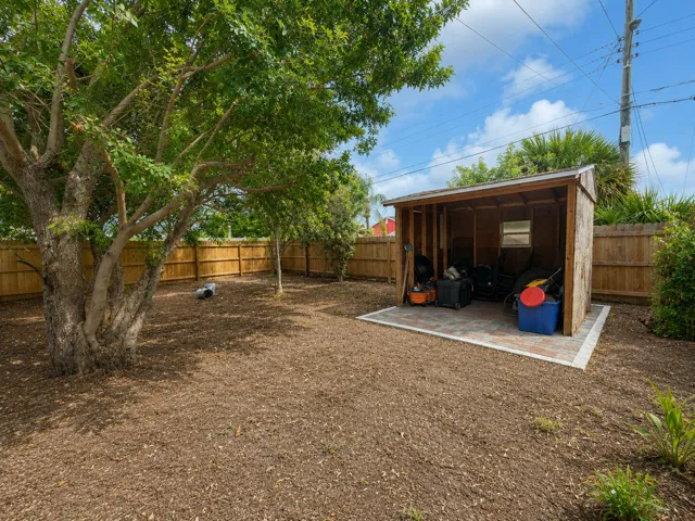Convenient storage shed tucked into the fenced backyard — great for tools, lawn equipment, or extra storage, set on a paver base for easy access.