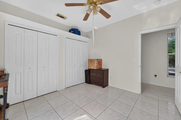 Recessed lighting, ceiling fan, tile flooring, and double bi-fold closet doors