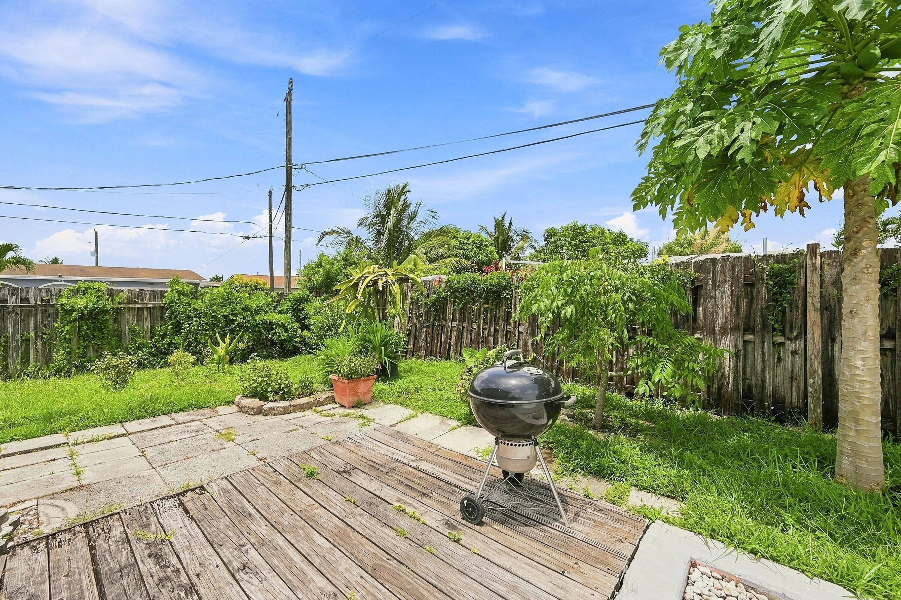 Outdoor patio area featuring a combination of wood-finish decking and stone pavers