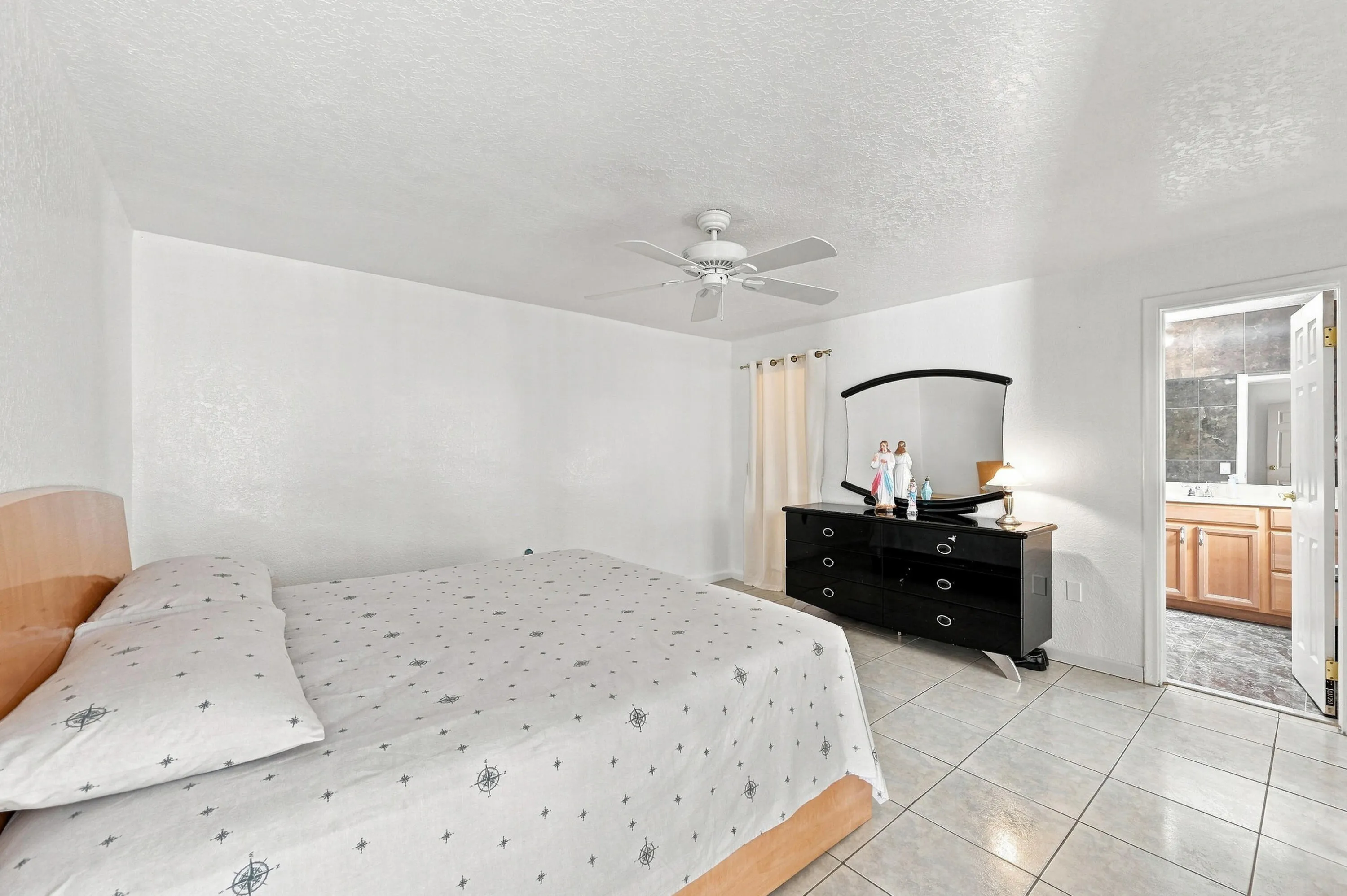 Tile flooring throughout this room and extending into the bathroom