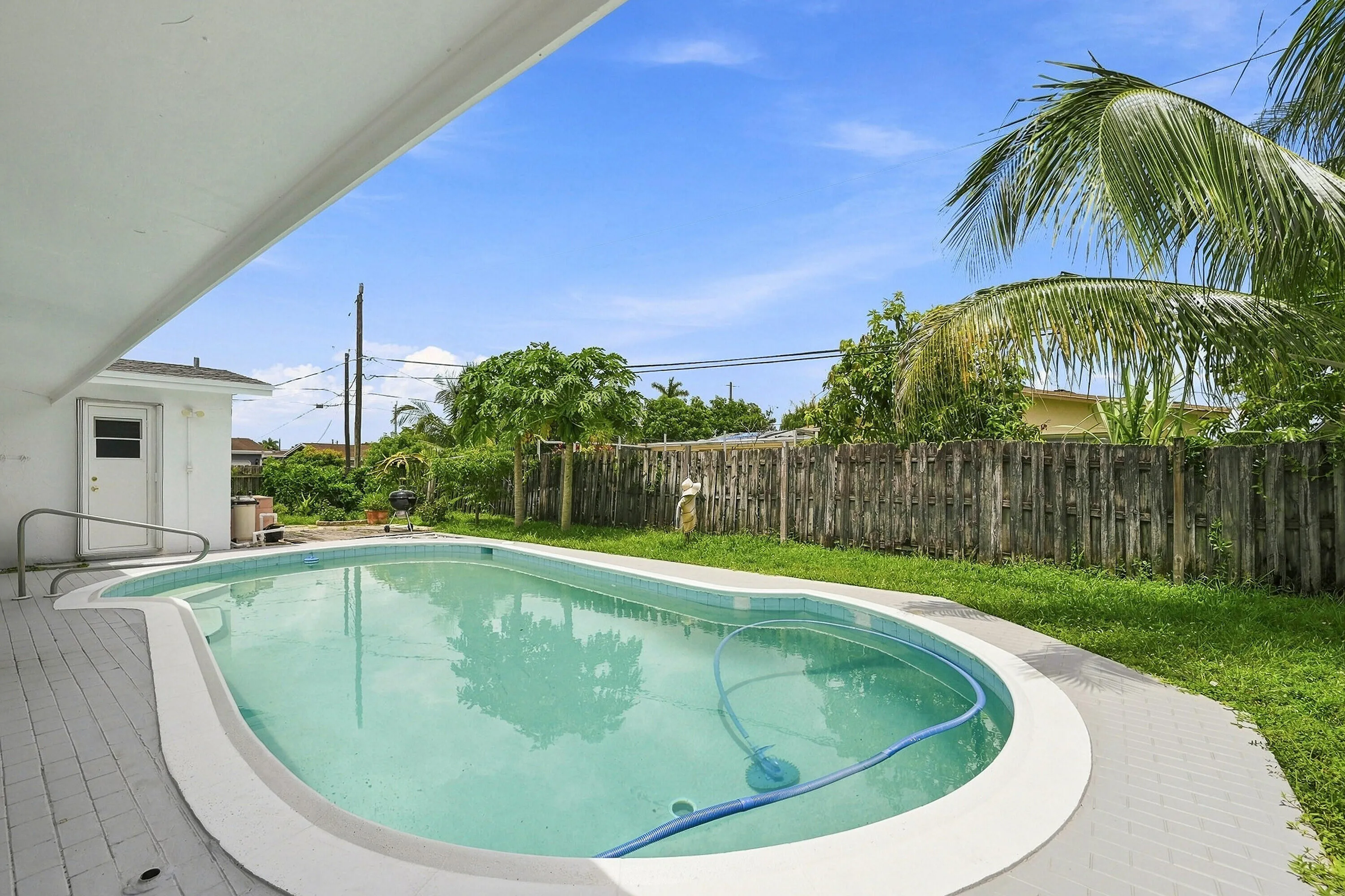 Outdoor swimming pool featuring a curved design and surrounding deck