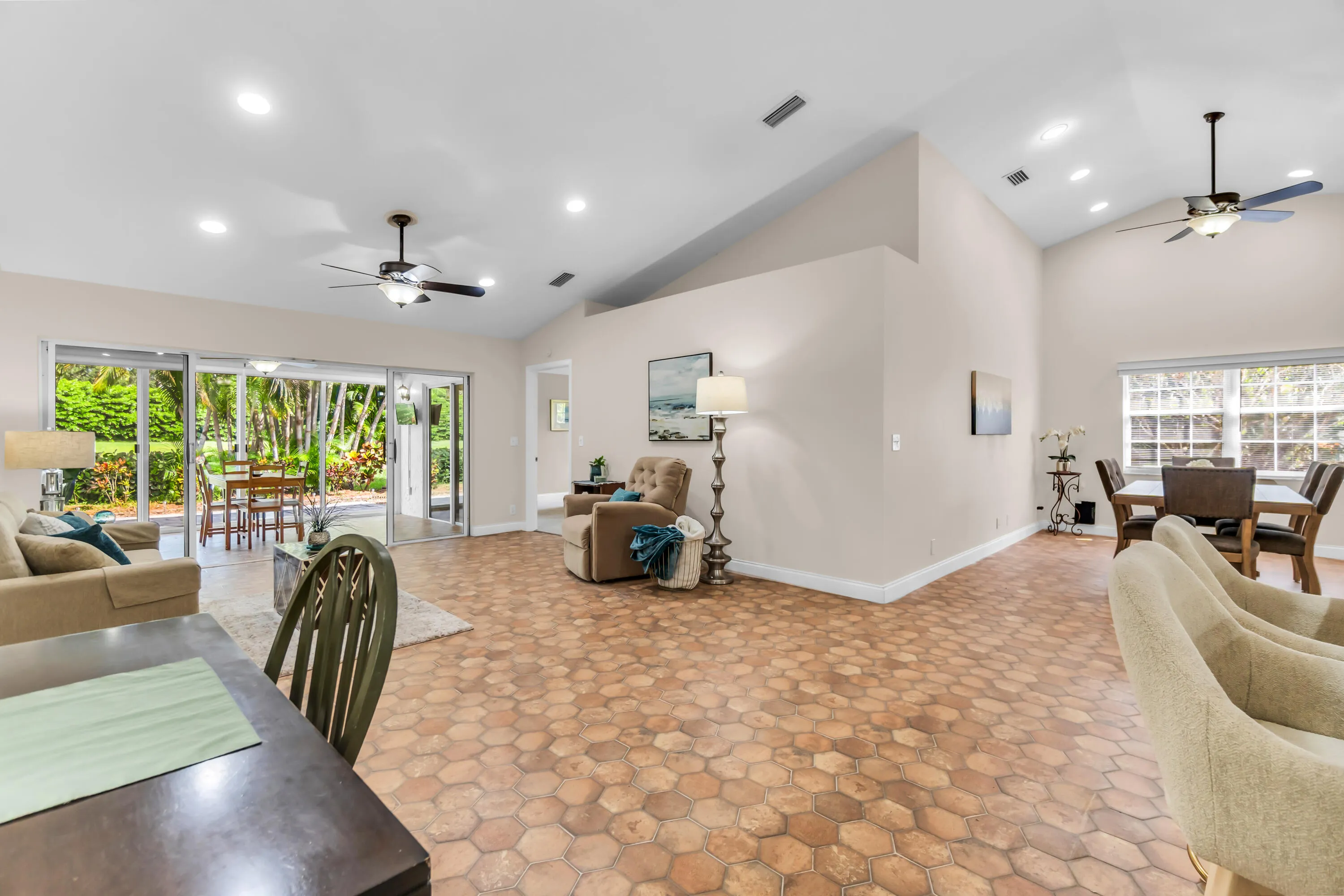 Expansive living area with vaulted ceilings and recessed lighting