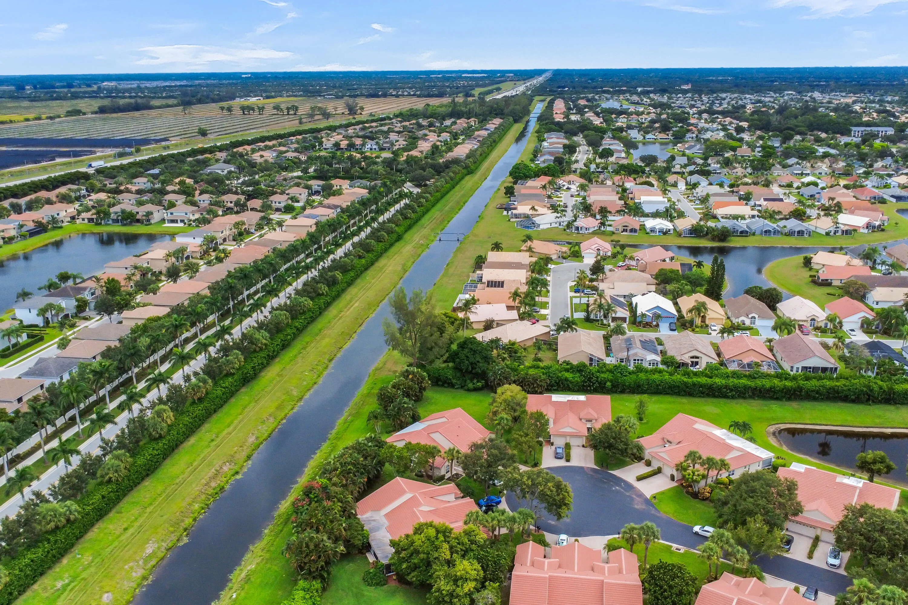 Aerial perspective highlighting a residential development with waterways and lush landscaping