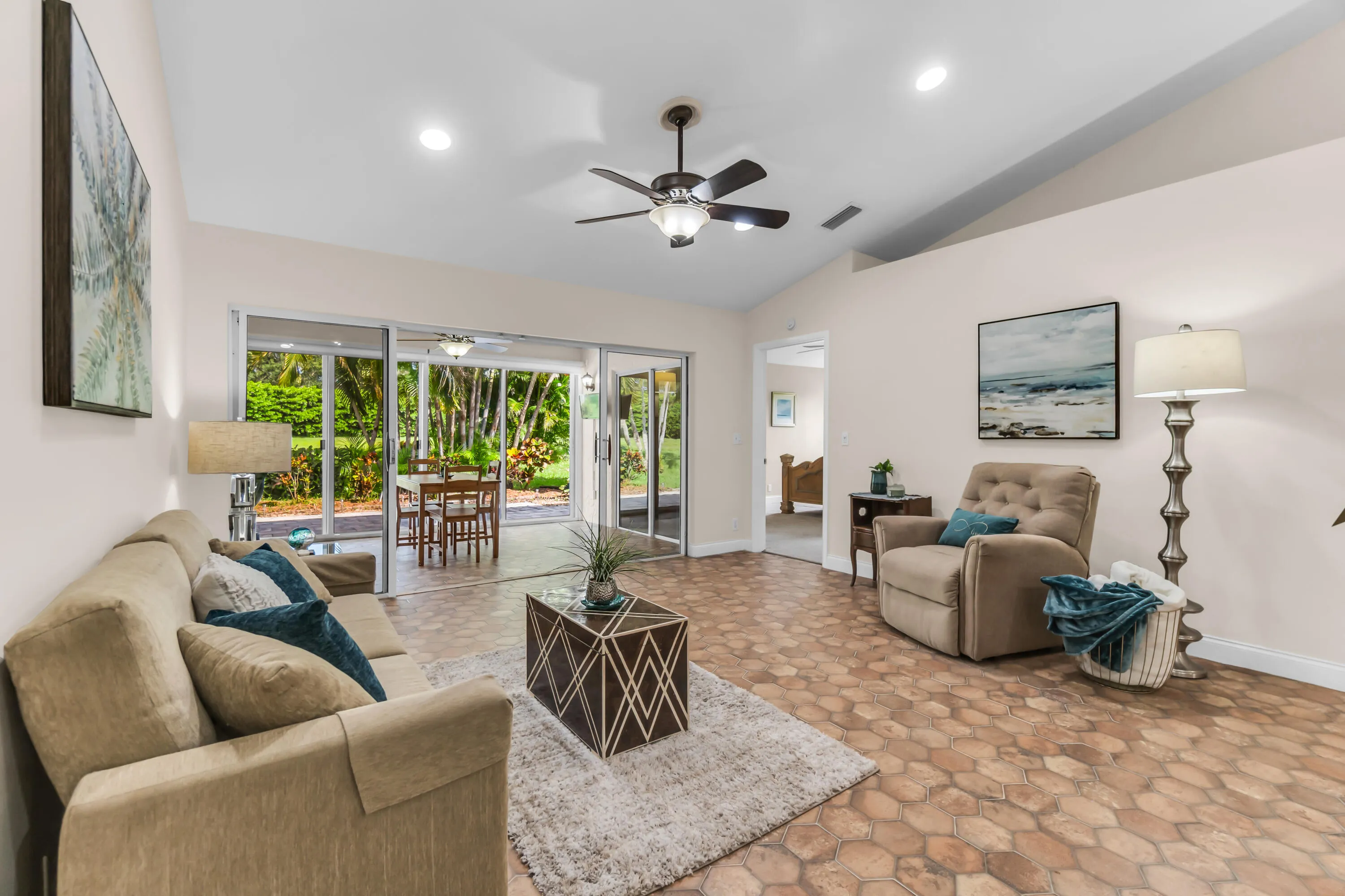 Vaulted ceiling living room featuring hexagon tile flooring, recessed lighting, and a ceiling fan