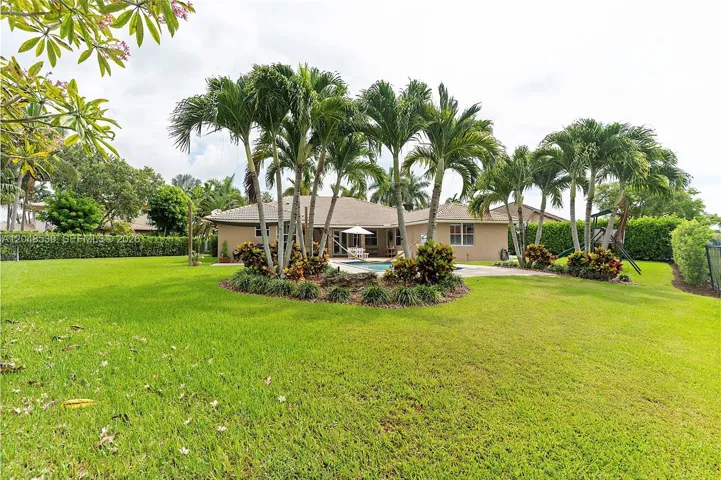 Home situated on largest lot in The Groves at Old Cutler