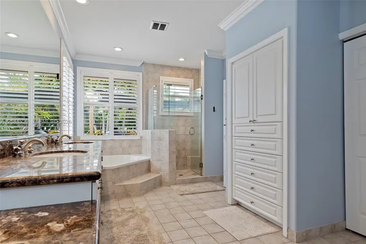 Spa-inspired bathroom with soaking tub, Separate walk-in shower, Dual vanities, Two walk-in closets