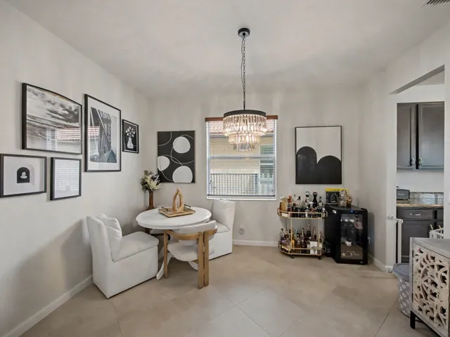 Recessed lighting and a tiered crystal chandelier illuminate the interior